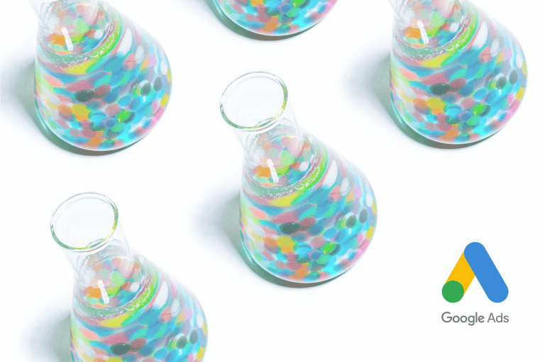 Colorful test tubes with the Google Ads logo in the bottom right corner