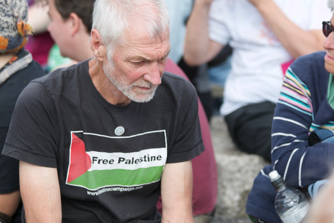 man wearing a shirt with a Palestinian flag
